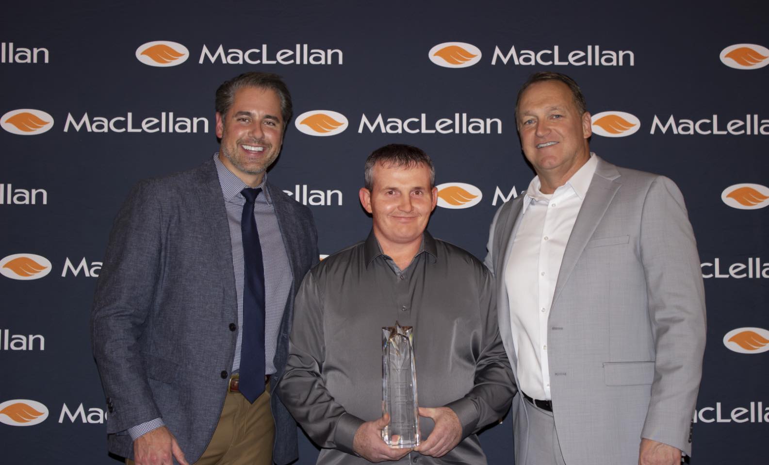 Group photo including (left to right) Mike Sausman, Jeremy Conn, and Bill Wilkins with Jeremy holdig his engraved crystal leadership award